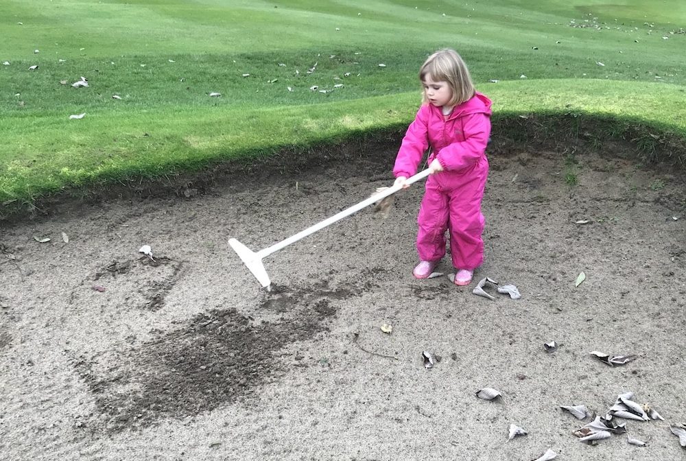 Lottie raking bunker